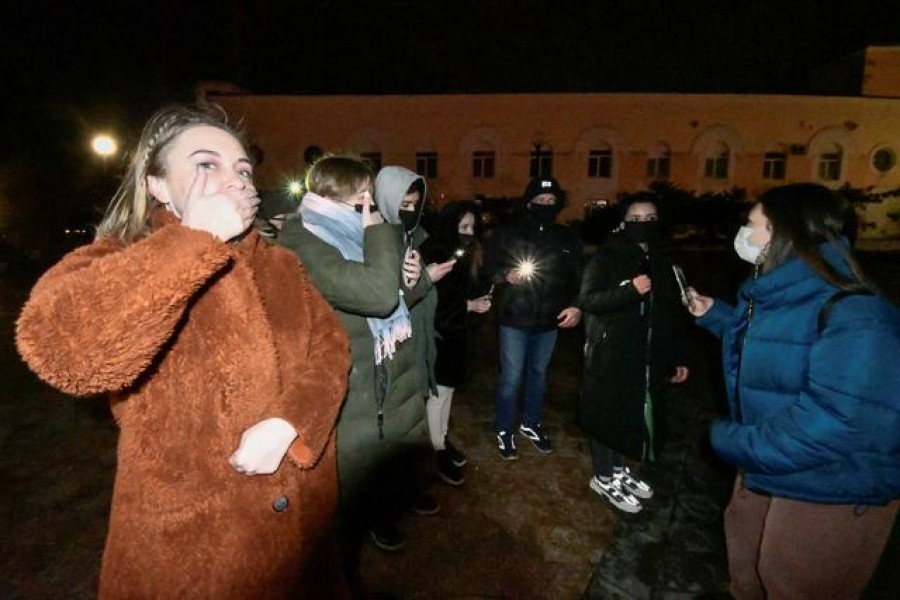 Supporters of Russian opposition politician Alexei Navalny, who was recently jailed for parole violations, use flashlights during a protest demonstration in Vladivostok, Russia February 14, 2021. REUTERS/Yuri Maltsev