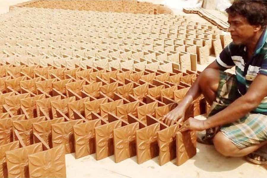 A man keeping tiles for drying at Kalaroa upazila in Jashore district — FE Photo