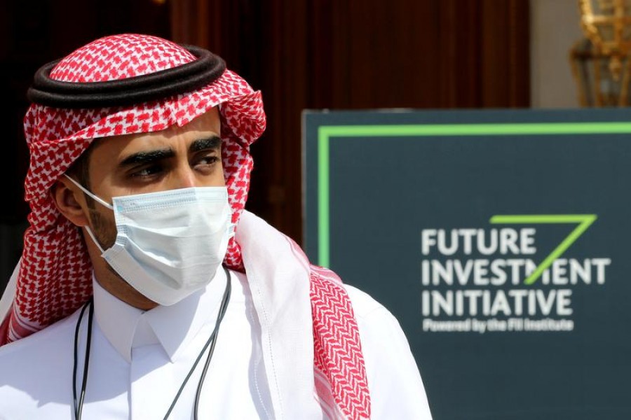 A Saudi man walks past a logo of the Future Investment Initiative ahead of the opening ceremony of the fourth annual conference in Riyadh, Saudi Arabia, January 27, 2021 — Reuters/Files