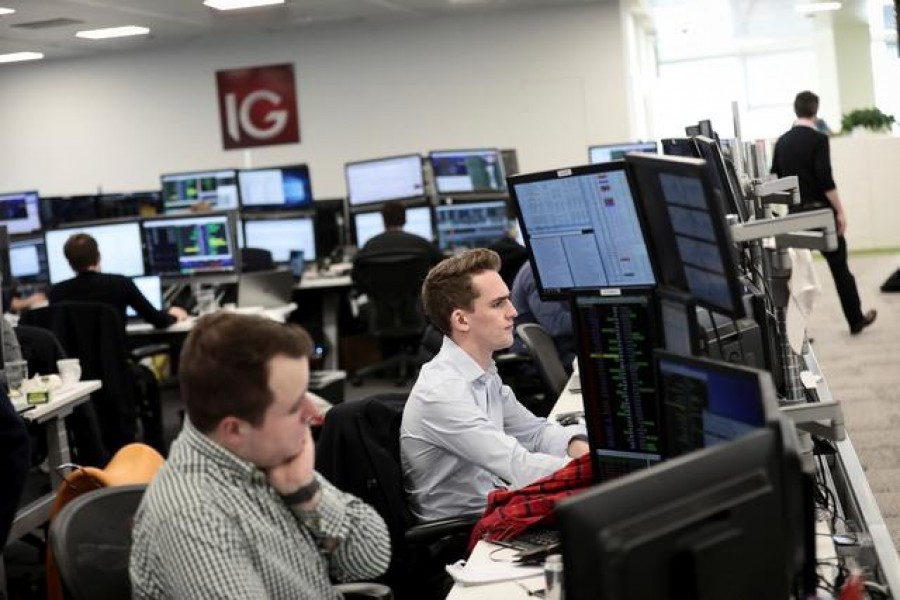 Traders look at financial information on computer screens on the IG Index trading floor in London, Britain February 6, 2018. REUTERS/Simon Dawson