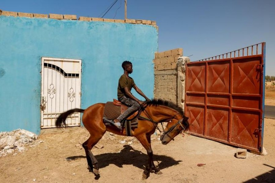 Fallou Diop, 19, a jockey, rides a young mare called Raissa Betty, whom he trains to compete with in the future, out of the Lambafar stable, in Niaga, Rufisque department, Senegal, January 27, 2021 — Reuters/Files