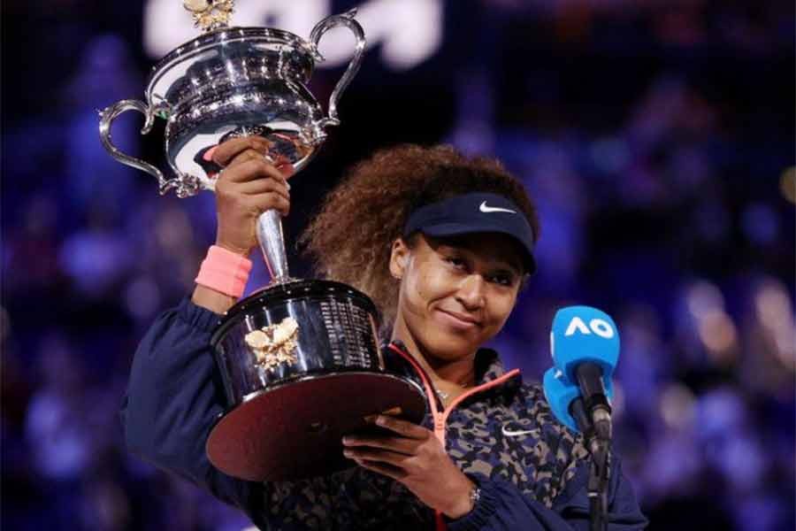 Japan's Naomi Osaka gives an interview as she celebrates with the trophy after winning her final match against Jennifer Brady of the US on Saturday -Reuters Photo