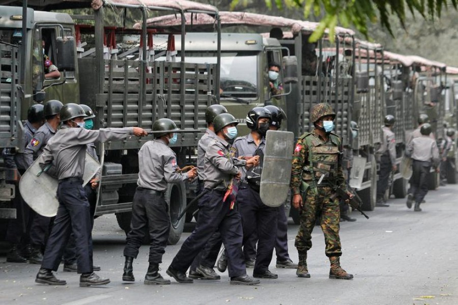 Police and soldiers are seen during a protests against the military coup, in Mandalay, Myanmar, February 20, 2021. REUTERS/Stringer