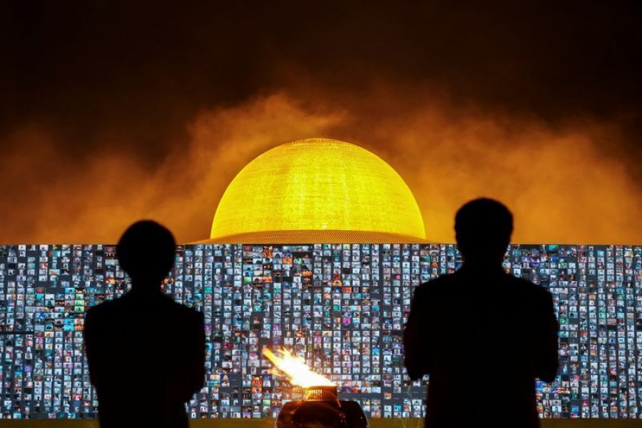 People pray as screens show devotees gathering via Zoom application during a ceremony to commemorate Makha Bucha Day at the Wat Phra Dhammakaya temple, following the spread of the coronavirus disease (Covid-19), in Pathum Thani province, Thailand on February 26, 2021 — Reuters photo