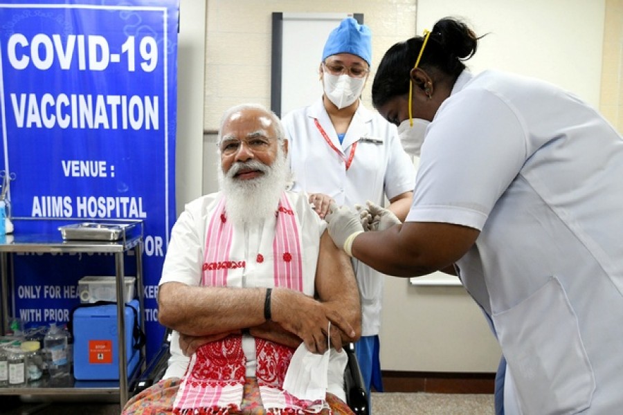 India's Prime Minister Narendra Modi receives a dose of COVAXIN, a coronavirus disease (COVID-19) vaccine developed by India's Bharat Biotech and the state-run Indian Council of Medical Research, at All India Institute of Medical Sciences (AIIMS) hospital in New Delhi, India, March 1, 2021. India's Press Information Bureau/Handout via REUTERS