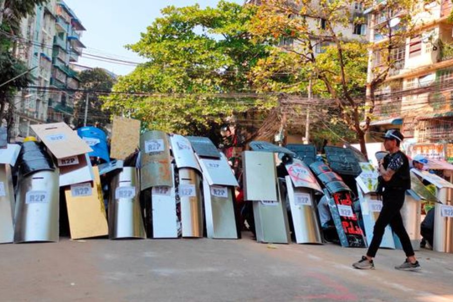 FILE PHOTO: Protesters set up a makeshift shield formation in preparation for potential clashes, in Yangon, Myanmar March 6, 2021, in this still image from a video obtained by Reuters.