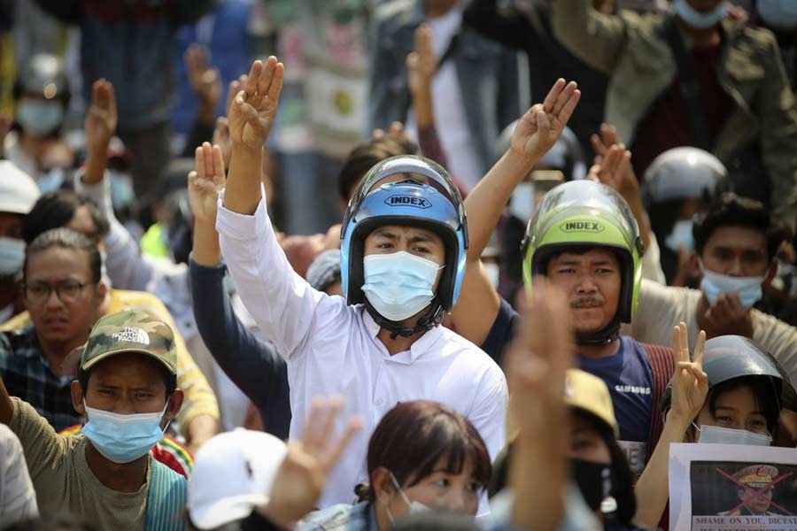 Anti-coup protesters flash a three-fingered sign of resistance during a demonstration in Naypyitaw in Myanmar on Monday –AP Photo