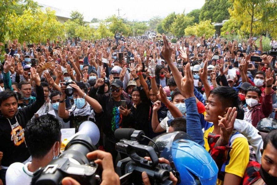 Supporters give the three-finger salute during Mya Thwate Thwate Khaing's funeral, a young woman protester who became the first death among anti-coup demonstrators after she was shot in the head when police tried to disperse a crowd during a protest, in Naypyitaw, Myanmar Feb 21, 2021 — Reuters/Files