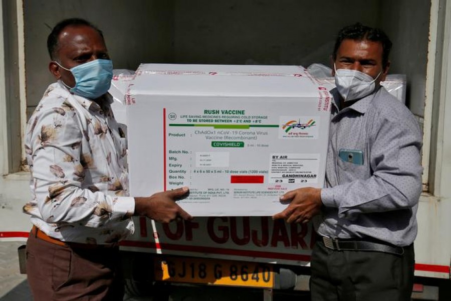 Officials unload boxes containing vials of AstraZeneca's COVISHIELD, a coronavirus disease (Covid-19) vaccine manufactured by Serum Institute of India, outside a vaccination storage centre in Ahmedabad, India on January 12, 2021 — Reuters/Files