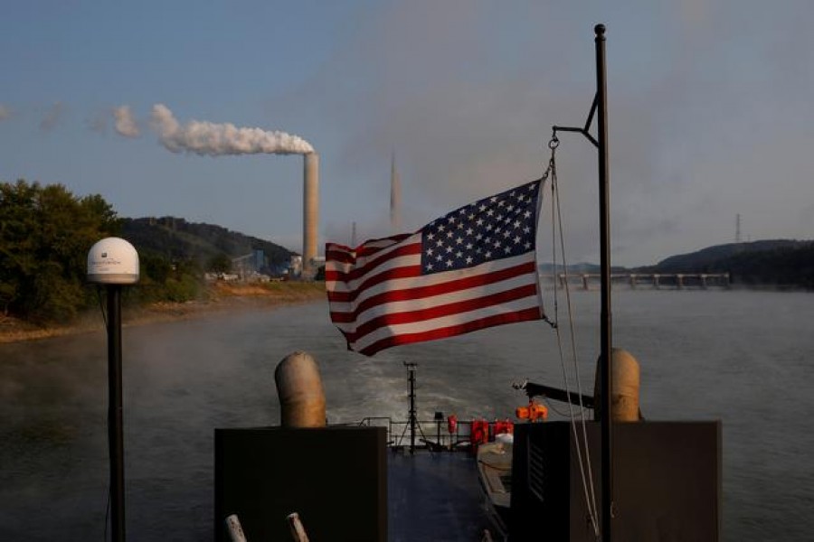 The US flag flies on a towboat as it passes the W H Sammis Power Plant, a coal-fired power-plant owned by FirstEnergy, along the Ohio River in Stratton, Ohio, US, September 10, 2017 — Reuters/Files