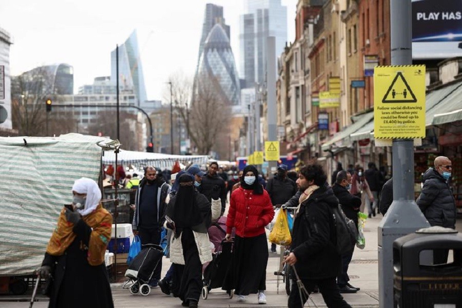 People walk past shops and market stalls, amid the coronavirus disease (Covid-19) outbreak in London, Britain, February 15, 2021 — Reuters/Files