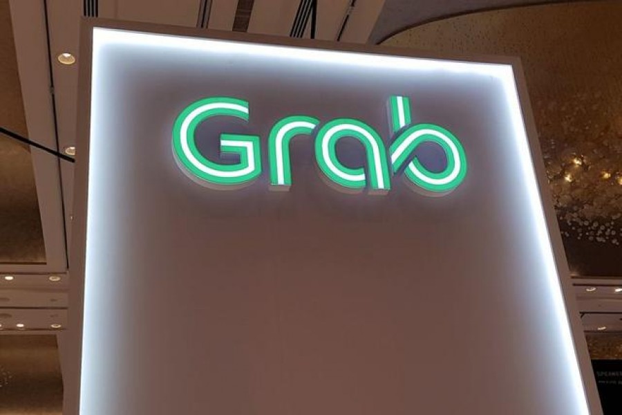 FILE PHOTO: A Grab logo is pictured at the Money 20/20 Asia Fintech Trade Show in Singapore March 21, 2019. Picture taken March 21, 2019. REUTERS/Anshuman Daga/File Photo