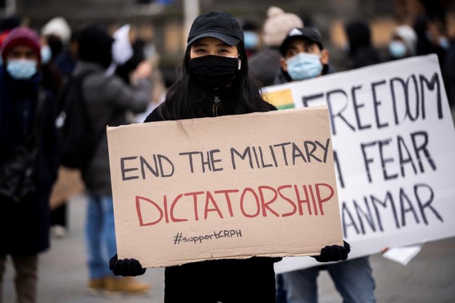 A woman holds a placard during a protest against the military coup in Myanmar, at Town Hall Square in Copenhagen, Denmark, March 13, 2021 — Ritzau Scanpix/Martin Sylvest via Reuters