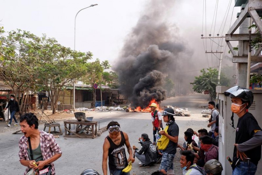 Demonstrators gather behind barricades during a protest against the military coup in Mandalay, Myanmar, March 22, 2021 — Reuters/Stringer