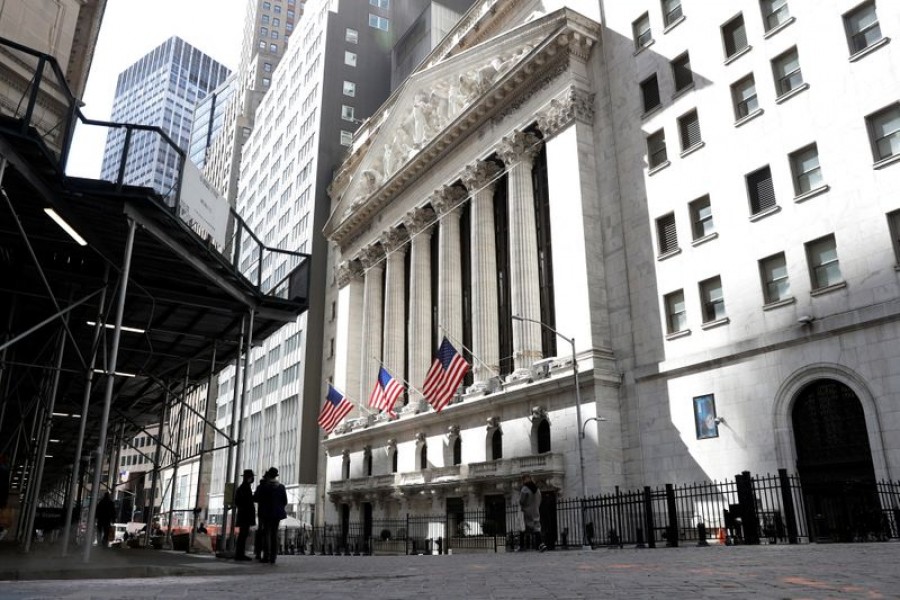 People are seen on Wall St outside the New York Stock Exchange (NYSE) in New York City, US, March 19, 2021 — Reuters