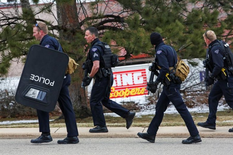 Law enforcement officers sweep the parking lot at the site of a shooting at a King Soopers grocery store in Boulder, Colorado, U.S. March 22, 2021. REUTERS/Kevin Mohatt