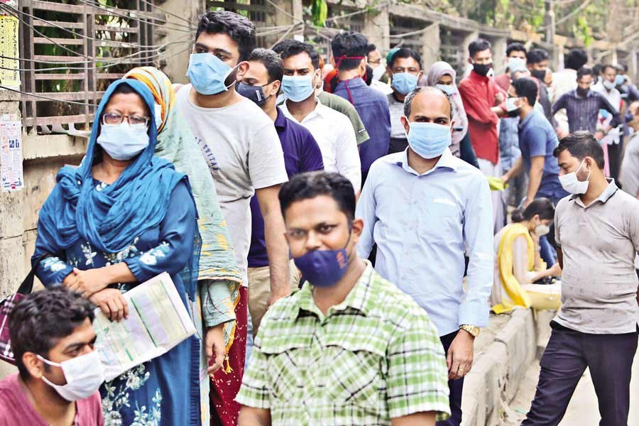 People waiting in a queue at Mugda Medical College Hospital in the city on Monday for COVID-19 tests —FE Photo by KAZ Sumon