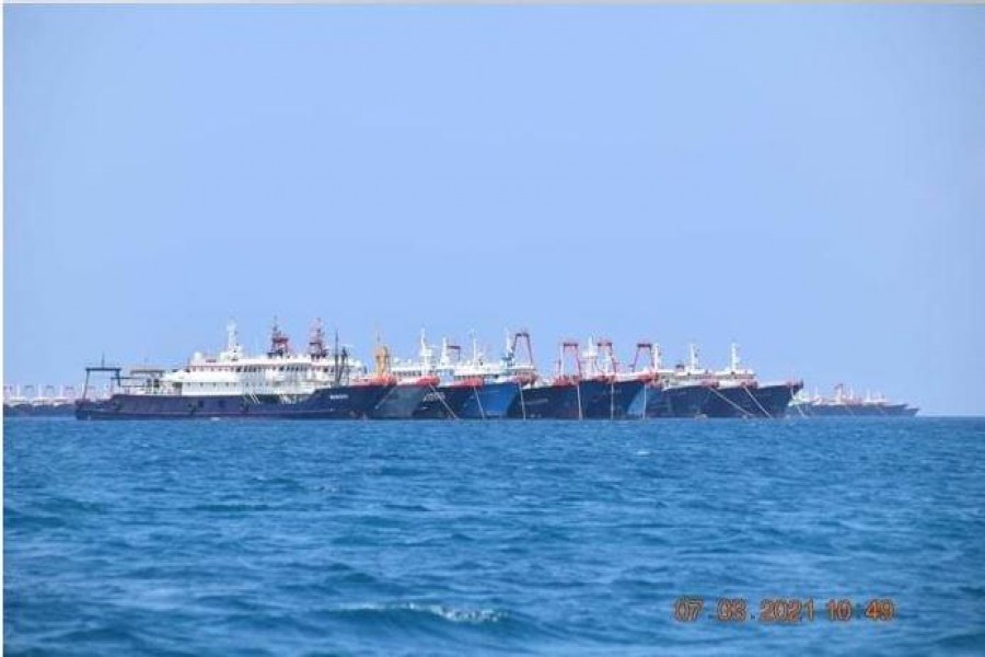 Some of the about 220 Chinese vessels reported by the Philippine Coast Guard, and believed to be manned by Chinese maritime militia personnel, are pictured at Whitsun Reef, South China Sea, March 7, 2021 — Philippine Coast Guard/National Task Force-West Philippine Sea/Handout via Reuters/Files