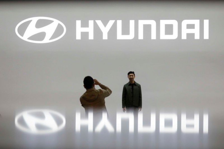 Visitors take photographs in front of the logo of Hyundai Motor during the 2019 Seoul Motor Show in Goyang, South Korea, March 28, 2019 — Reuters/Files