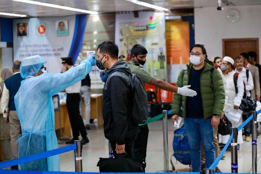 Officials at Hazrat Shahjalal International Airport checking passengers with thermal scanner as a preventive measure against coronavirus in Dhaka last year –Reuters file photo