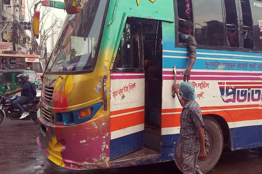 A person requesting a conductor to get in a bus at the Purana Paltan area in the city on Wednesday afternoon -FE Photo