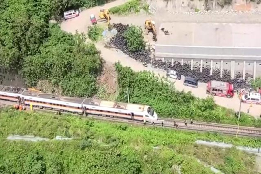 Rescue workers walk next to a damaged train which derailed in a tunnel north of Hualien, Taiwan April 2, 2021, in this still image taken from video. FTV via Reuters