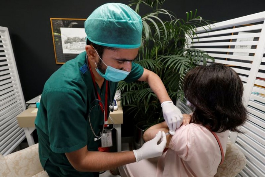 A resident receives a commercial dose of Russia's Sputnik V coronavirus disease (COVID-19) vaccine, at a private hospital in Karachi, Pakistan April 4, 2021. REUTERS/Akhtar Soomro