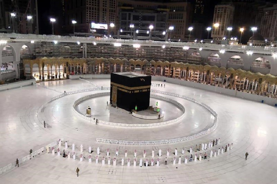 A small group of worshippers pray at Kaaba in the Grand Mosque while practicing social distancing, following the outbreak of the coronavirus disease (Covid-19), during the holy month of Ramadan, in the holy city of Mecca, Saudi Arabia, May 4, 2020 — Saudi Press Agency/Handout via Reuters/File Photo