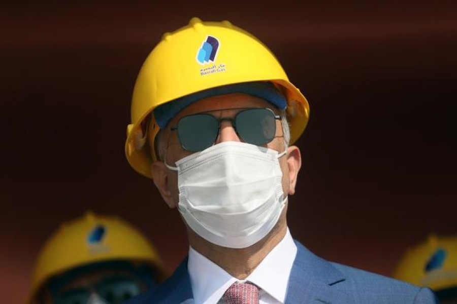 FILE PHOTO: Iraq's Prime Minister Mustafa al-Kadhimi looks on as he wears a face mask at the central station gas processing plant at Rumaila oilfield in Basra, Iraq, November 5, 2020. REUTERS/Essam Al-Sudani