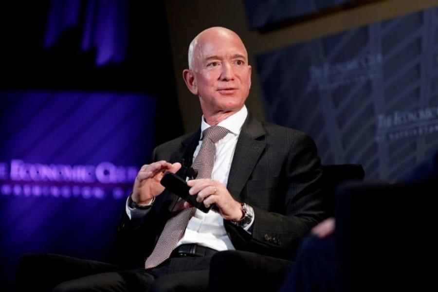 FILE PHOTO: Jeff Bezos, president and CEO of Amazon and owner of The Washington Post, speaks at the Economic Club of Washington DC's "Milestone Celebration Dinner" in Washington, US, September 13, 2018. REUTERS/Joshua Roberts/File Photo