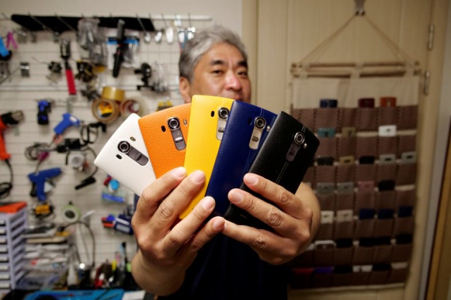 Ryu Hyun-soo, 53, holds his LG smartphones in Anyang, South Korea April 12, 2021. REUTERS/Daewoung Kim