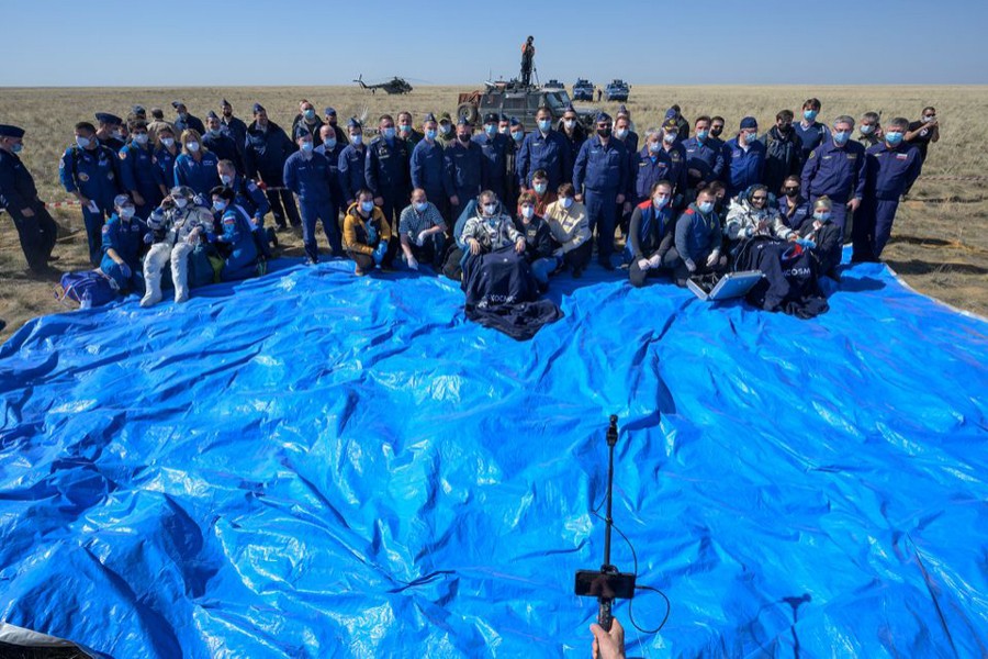 The International Space Station (ISS) crew members Kathleen Rubins of NASA, Sergey Ryzhikov and Sergey Kud-Sverchkov of Roscosmos pose for a picture after landing with the Soyuz MS-17 space capsule in a remote area outside Zhezkazgan, Kazakhstan on April 17, 2021 — NASA handout via REUTERS