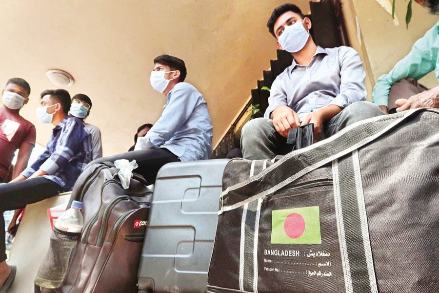 Migrant workers who failed to fly to their destinations due to flight suspension waiting outside the Biman Bangladesh Airlines office in the city on Saturday for the new flight schedule — FE photo