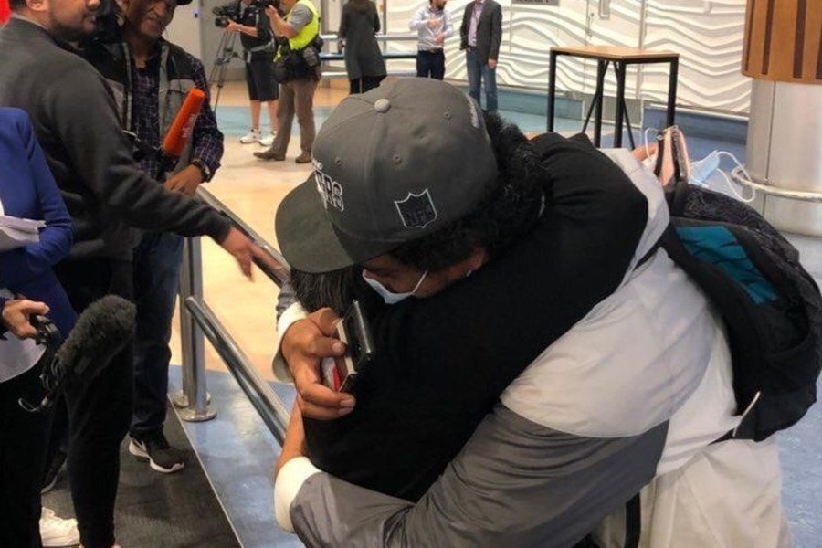 - Two people embrace at Auckland airport