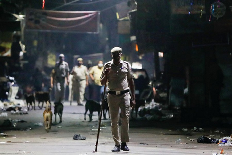 A police officer patrols on a deserted street during a curfew to limit the spread of the coronavirus disease (COVID-19), in New Delhi, India, Apr 6, 2021. REUTERS