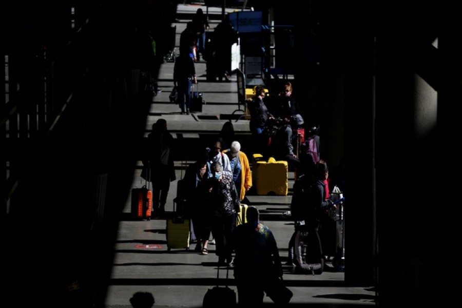 Travellers walk through a pick-up area in the arrivals section at Seattle-Tacoma International Airport in SeaTac, Washington, US, April 12, 2021 — Reuters/Files