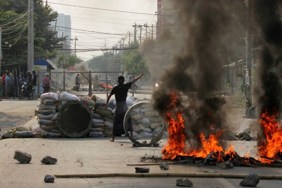 A demonstrator gestures near a barricade during a protest against the military coup in Mandalay, Myanmar, March 22, 2021 — Reuters/Files