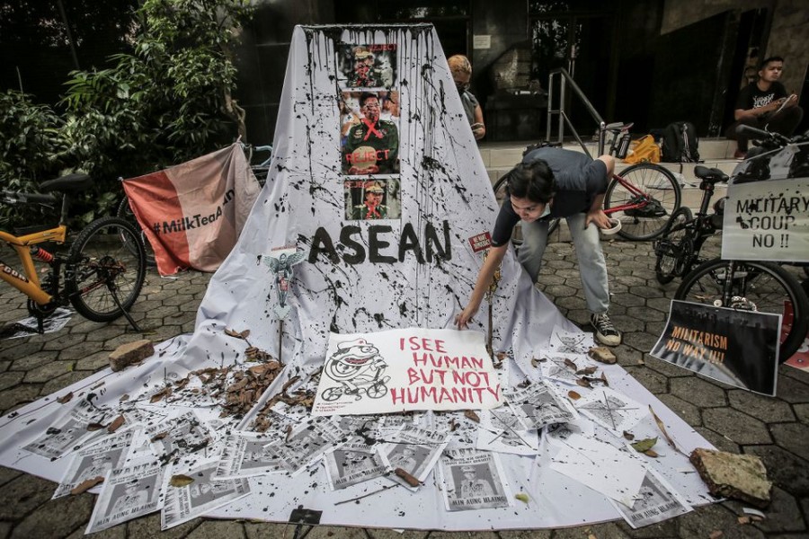 A woman prepares a placard out of crossed out portraits of Myanmar's junta chief Senior General Min Aung Hlaing during protest against the military coup in Myanmar, in Jakarta, Indonesia, April 24, 2021 in this photo taken by Antara Foto. Antara Foto/Dhemas Reviyanto/ via REUTERS