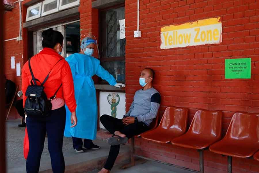 A health worker interrogating a patient (R) arriving with breathing difficulty at a hospital for treatment on Monday as the major second wave of coronavirus disease (COVID-19) surges in Nepal -Reuters photo