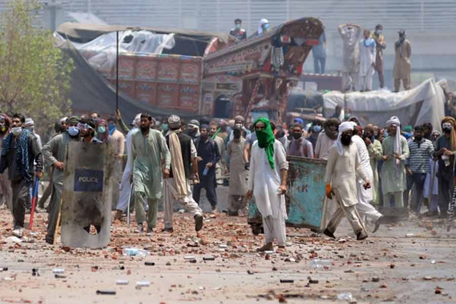 Supporters of the banned Islamist political party Tehrik-e-Labaik Pakistan (TLP) with sticks and stones block a road during a protest in Lahore of Pakistan on April 18 this year -Reuters file photo