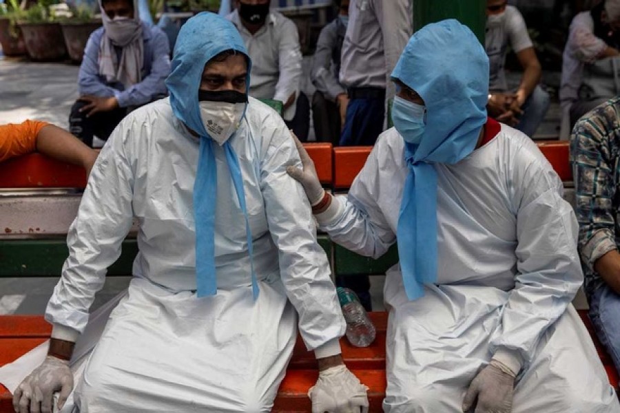 A man is consoled by his brother after their father died due to the coronavirus disease, at a crematorium ground in New Delhi, India, April 28, 2021 - Reuters photo