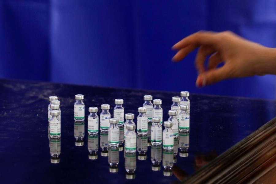 A health worker counts used vials of Sinopharm's coronavirus disease (COVID-19) vaccine, at a vaccination centre in Karachi, Pakistan, April 28, 2021. REUTERS