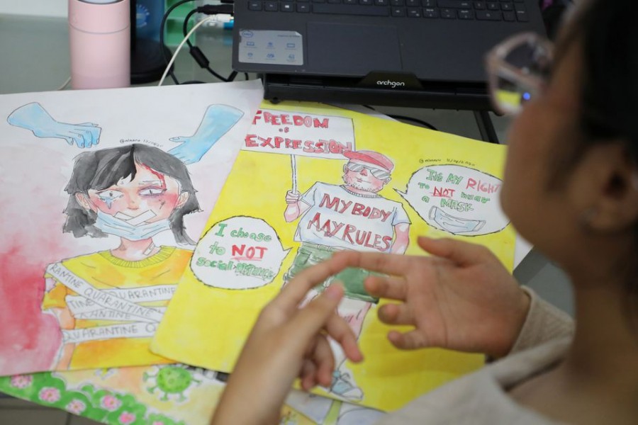 Malaysian teenager Ain Husniza Saiful Nizam shows her artworks during an interview with Reuters in Kuala Selangor, Malaysia April 29, 2021. REUTERS/Lim Huey Teng