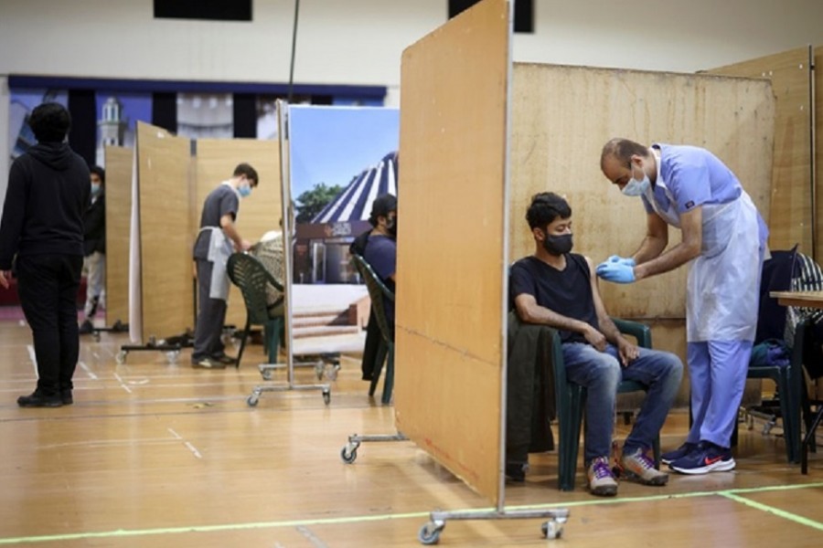 A man receives an injection with a dose of AstraZeneca coronavirus vaccine, at a vaccination centre in Baitul Futuh Mosque, amid the outbreak of coronavirus disease (COVID-19), in London, Britain, Mar 28, 2021. REUTERS