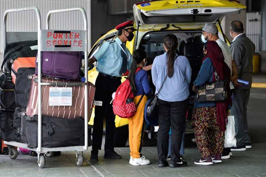 A porter loading the luggage of recently arrived air travellers from New Delhi, into a cab after Canada's government temporarily barred passenger flights from India and Pakistan for 30 days, at Vancouver International Airport in Richmond, British Columbia, Canada, recently -Reuters file photo