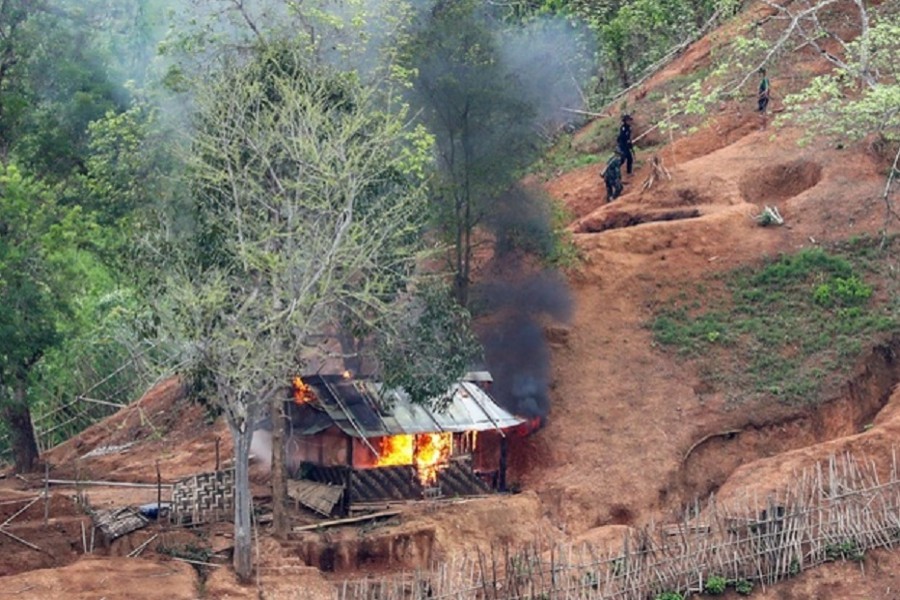 Ethnic minority Karen troops are seen after setting fire to a building inside a Myanmar army outpost near the Thai border, which is seen from the Thai side on the Thanlwin, also known as Salween, riverbank in Mae Hong Son province, Thailand, April 28, 2021. Reuters