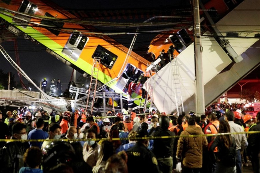 Rescuers work at a site where an overpass for a metro partially collapsed with train cars on it at Olivos station in Mexico City, Mexico on May 3, 2021 — Reuters photo