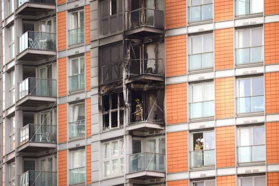 Firefighters work at a damaged residential building in East London on Friday -Reuters photo