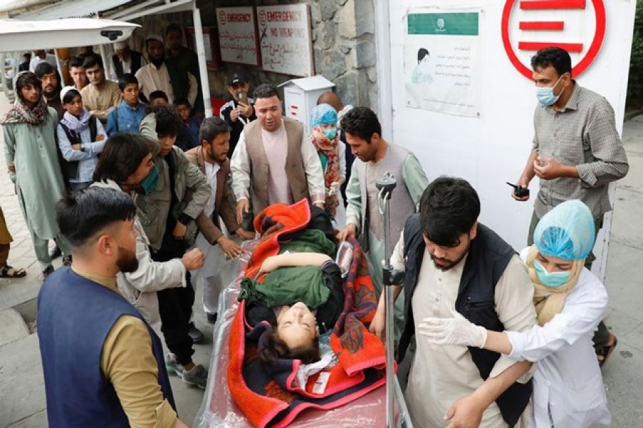 A woman being taken to a hospital following a bombing in Kabul on Saturday — Reuters