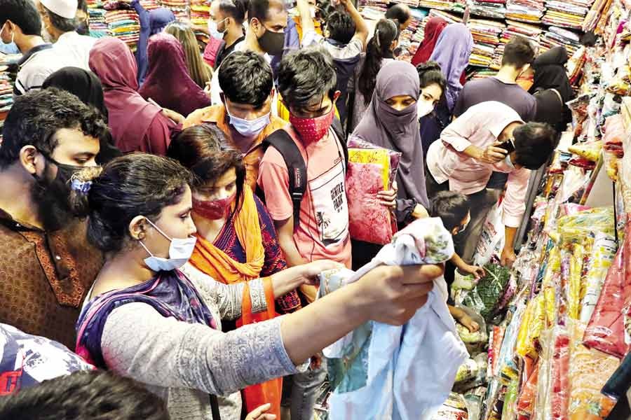 With Eid drawing nearer, shoppers throng markets in the city to buy dresses for their near and dear ones. The photo was taken at Gausia Market in the city on Saturday —FE Photo